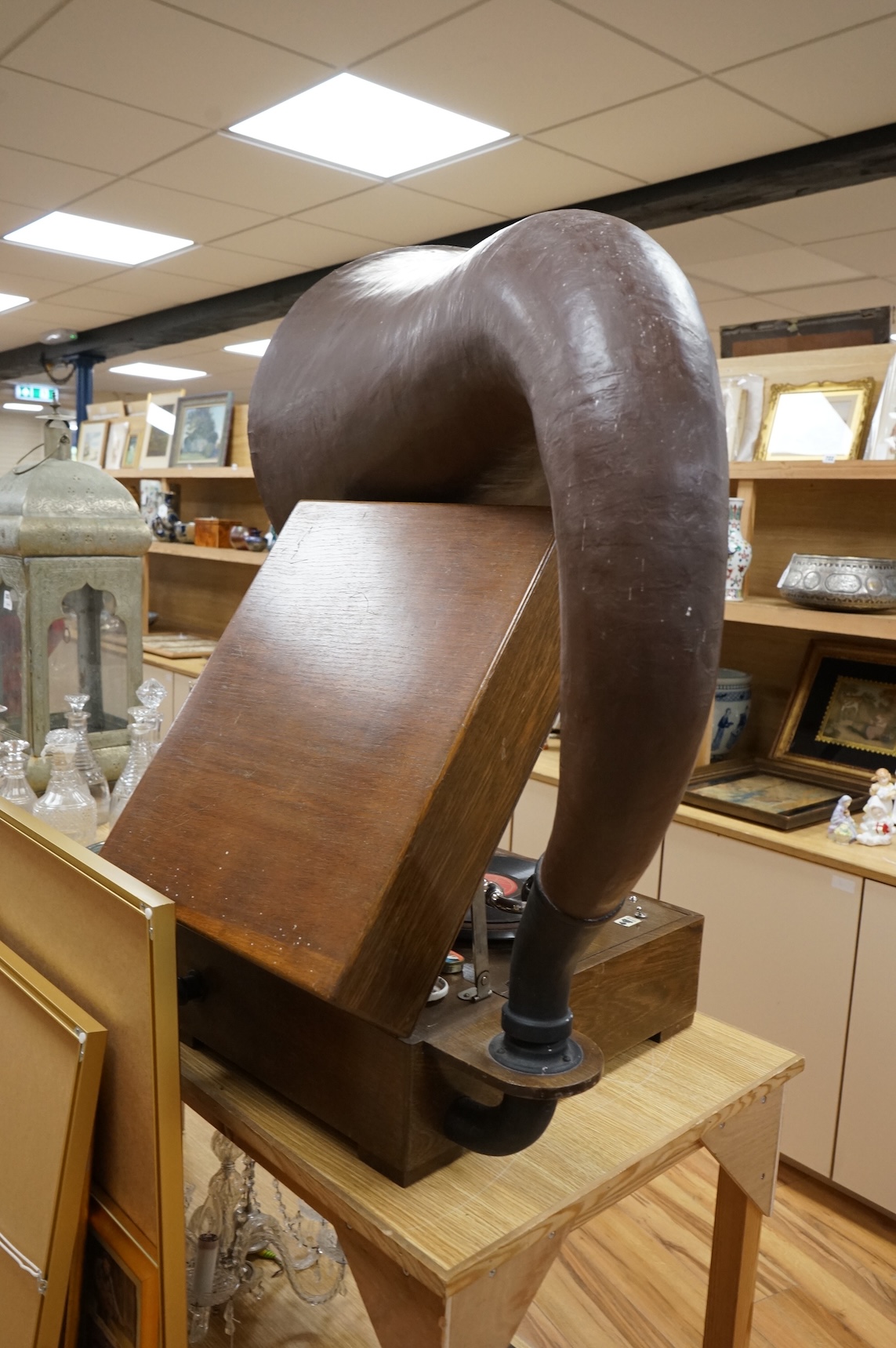 An EMG ‘Handmade Gramophone’ with electrically powered motor, in an oak veneered case with large papier-mâché horn, dimensions of the case; 44 x 53 x 27cm, diameter of the horn 56cm.